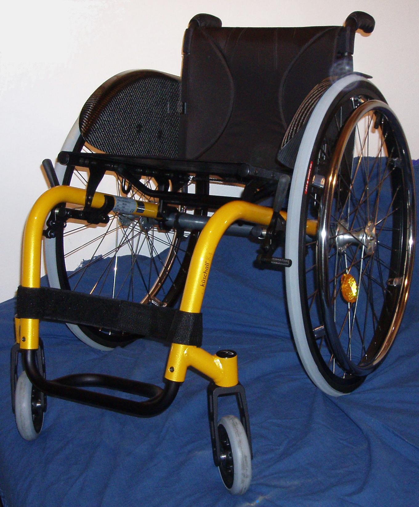 Figure 11.2 — Küschall K4 Rigid-Frame Ultralight Wheelchair (three-quarter view showing rear axle plate, casters, and frame geometry)